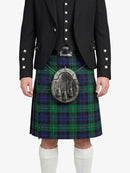 Person wearing a black jacket and green plaid kilt with a sporran on a white background