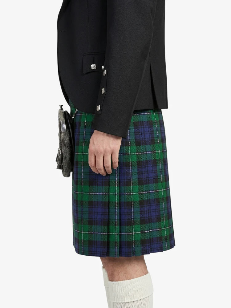 Person wearing a black jacket and green plaid kilt on a white background