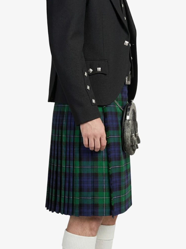 Person wearing a black jacket and green plaid kilt on a white background