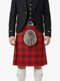 Person wearing a red tartan kilt with a black jacket on a white background