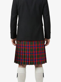 Person wearing a black jacket and red plaid kilt on a white background