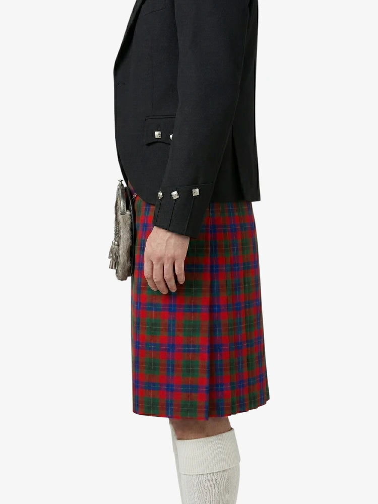 Person wearing a black jacket and red plaid kilt on a white background