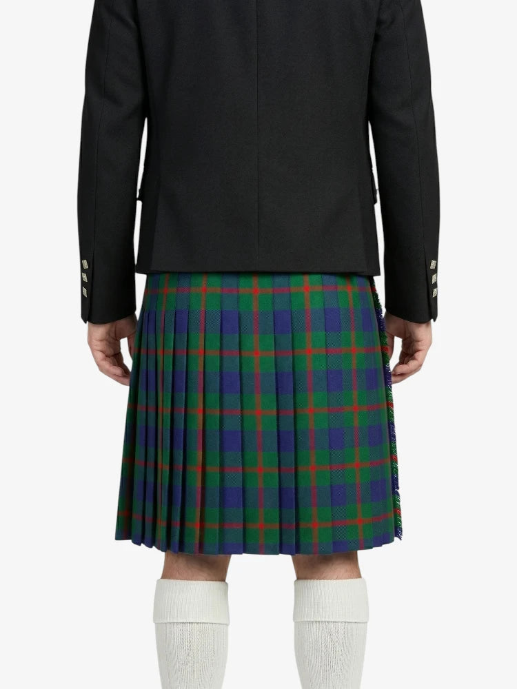 Person wearing a black jacket and green plaid kilt on a white background