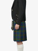 Person wearing a black blazer and a plaid kilt on a white background