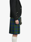 Person wearing a black jacket and a green plaid kilt on a white background