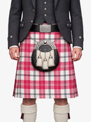 Person wearing a traditional Scottish kilt with a tartan pattern on a white background