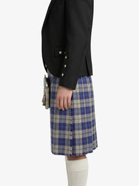 Person wearing a black jacket and blue plaid kilt on a white background