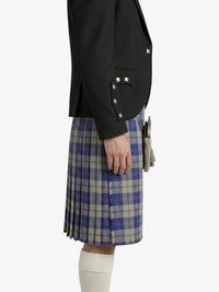 Person wearing a black blazer and blue plaid kilt on a white background
