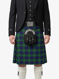 Person wearing a traditional Scottish kilt with a tartan pattern on a white background
