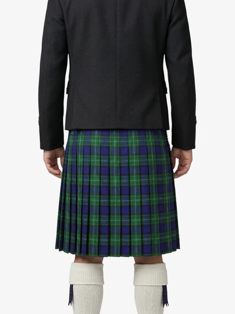 Person wearing a black jacket and green plaid kilt on a white background