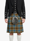 Person wearing a traditional Scottish kilt with a tartan pattern on a white background