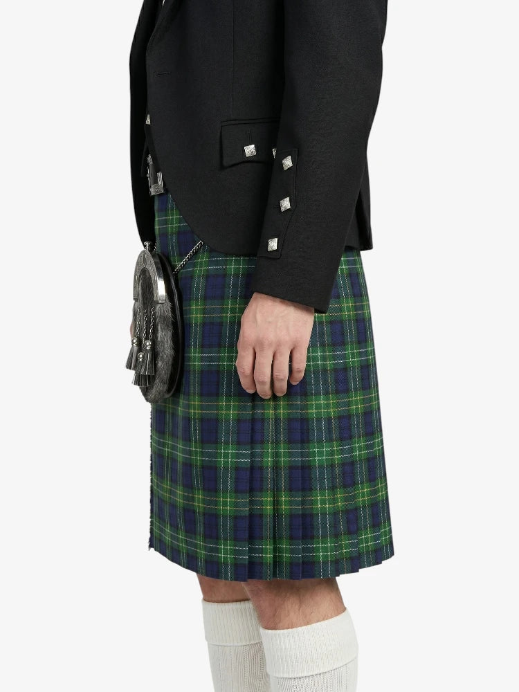 Person wearing a black blazer and green plaid kilt on a white background