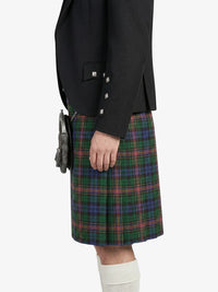 Person wearing a black jacket and plaid kilt on a white background