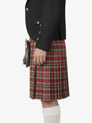 Person wearing a black jacket and red plaid kilt on a white background