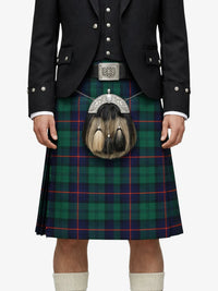 Person wearing a traditional Scottish kilt with a tartan pattern on a white background