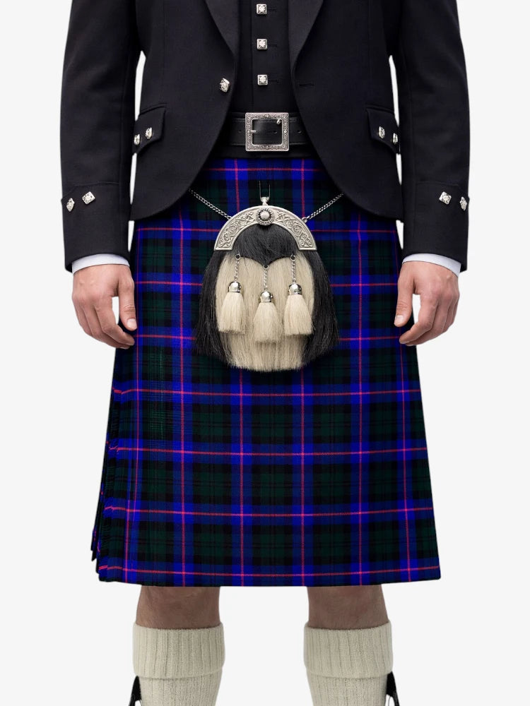 Person wearing a traditional Scottish kilt with a tartan pattern on a white background