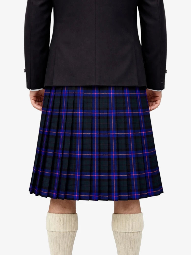 Person wearing a black jacket and plaid kilt on a white background