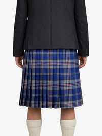 Person wearing a dark jacket and blue plaid kilt on a white background