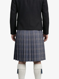 Person wearing a black jacket and plaid kilt on a white background