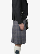Person wearing a dark jacket and plaid kilt on a white background