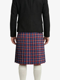 Person wearing a black jacket and red and blue plaid kilt on a white background