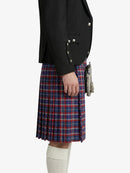 Person wearing a black jacket and red plaid kilt on a white background