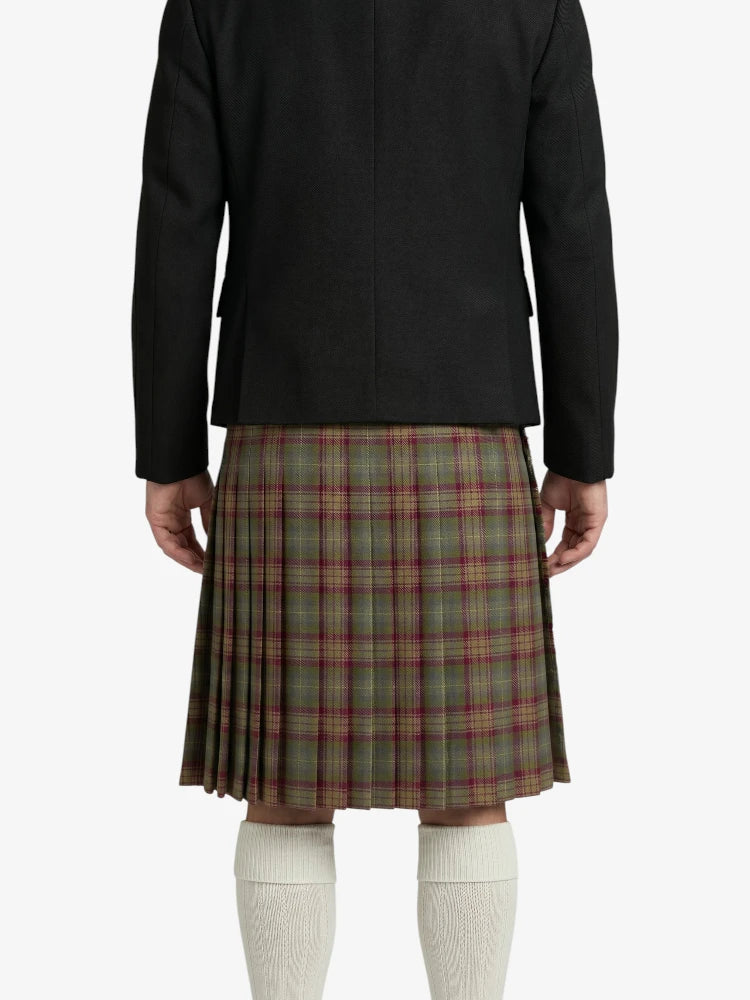 Person wearing a black jacket and plaid kilt on a white background