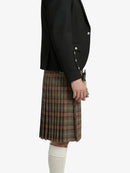 Person wearing a black jacket and plaid kilt on a white background