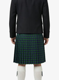 Person wearing a black jacket and green plaid kilt on a white background