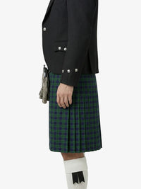 Person wearing a black jacket and green plaid kilt on a white background