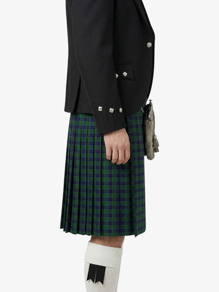 Person wearing a black jacket and green plaid kilt on a white background