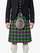 Person wearing a traditional Scottish kilt with a tartan pattern on a white background