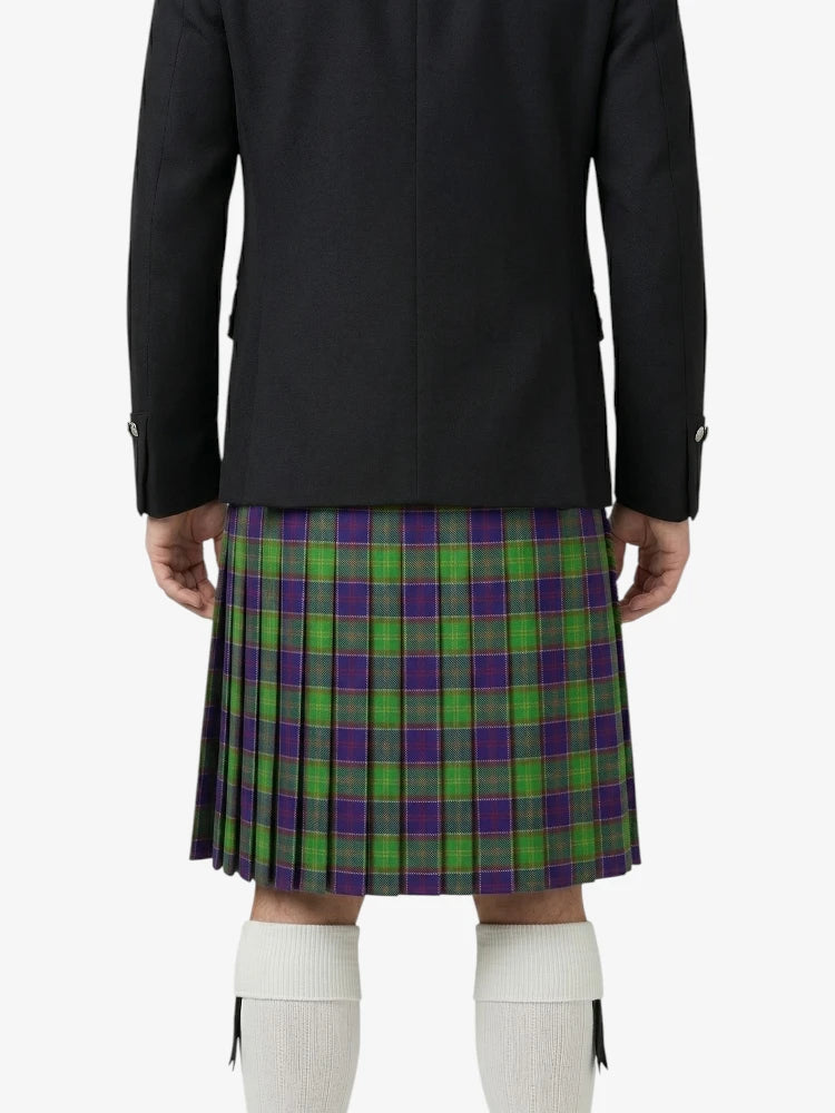Person wearing a black coat and green plaid kilt on a white background