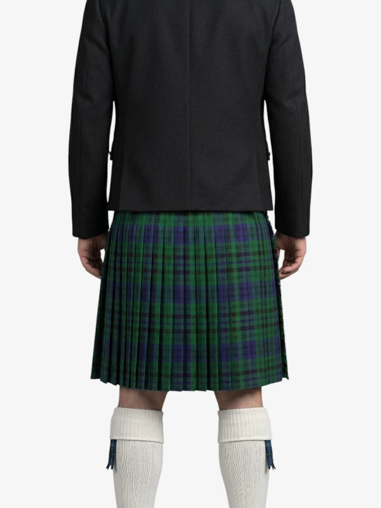 Person wearing a black jacket and green plaid kilt on a white background