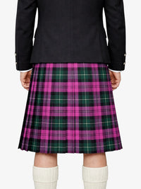Person wearing a black jacket and pink plaid kilt on a white background