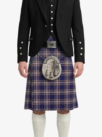 Person wearing a traditional Scottish kilt with a jacket on a white background