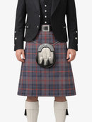 Person wearing a traditional Scottish kilt with a jacket and sporran on a white background