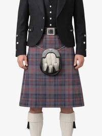 Person wearing a traditional Scottish kilt with a jacket and sporran on a white background