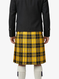 Person wearing a black coat and yellow plaid kilt on a white background