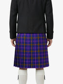 Person wearing a black jacket and purple plaid kilt on a white background