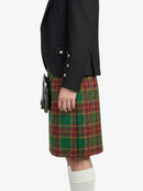 Person wearing a black blazer and green plaid kilt on a white background