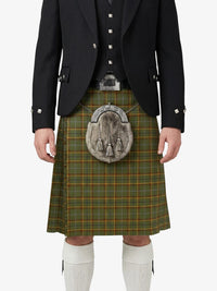 Person wearing a traditional Scottish kilt with a jacket on a white background