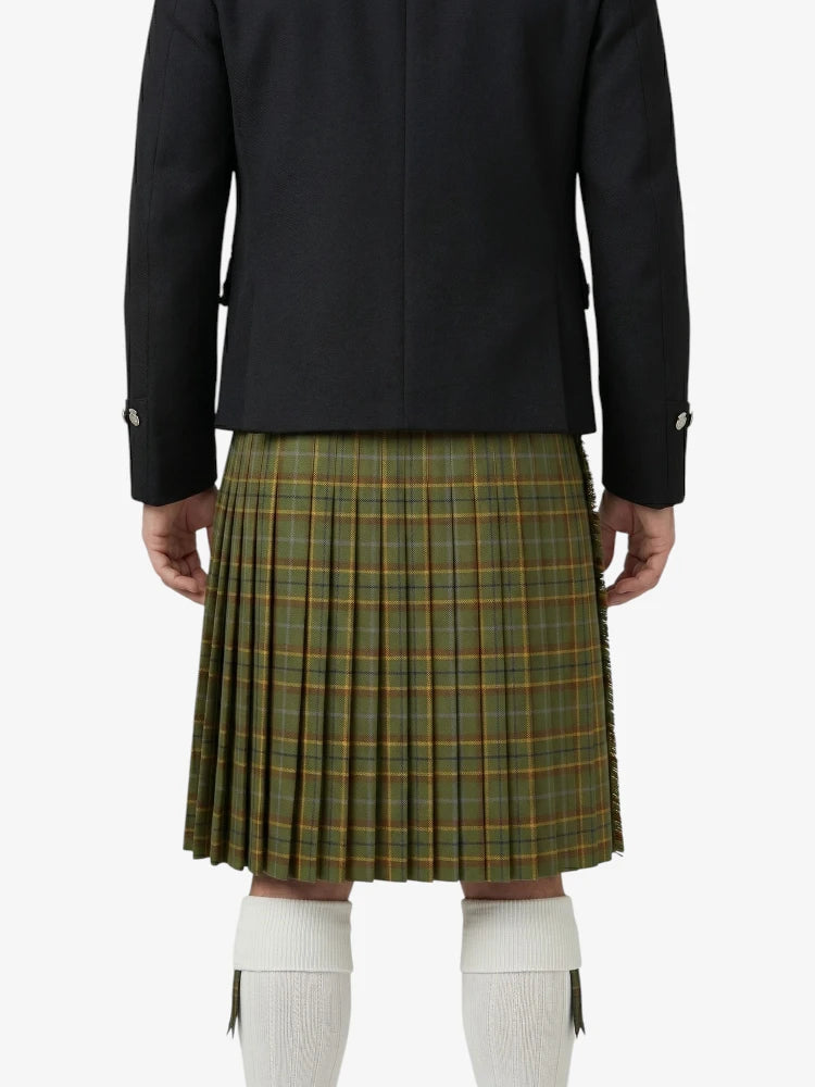 Person wearing a black jacket and green plaid kilt on a white background