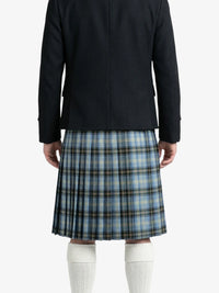 Person wearing a black coat and blue plaid kilt on a white background