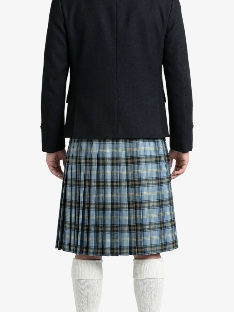 Person wearing a black coat and blue plaid kilt on a white background