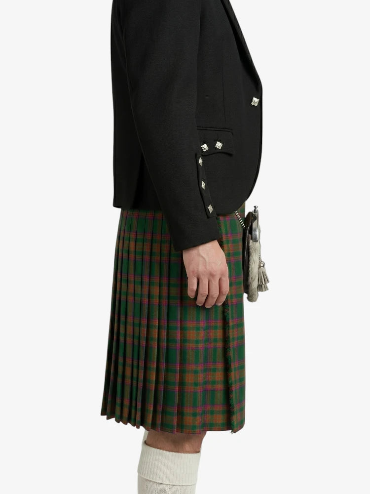 Person wearing a black jacket and green plaid kilt on a white background