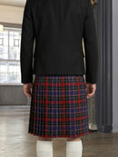 Person wearing a black jacket and red plaid kilt indoors.