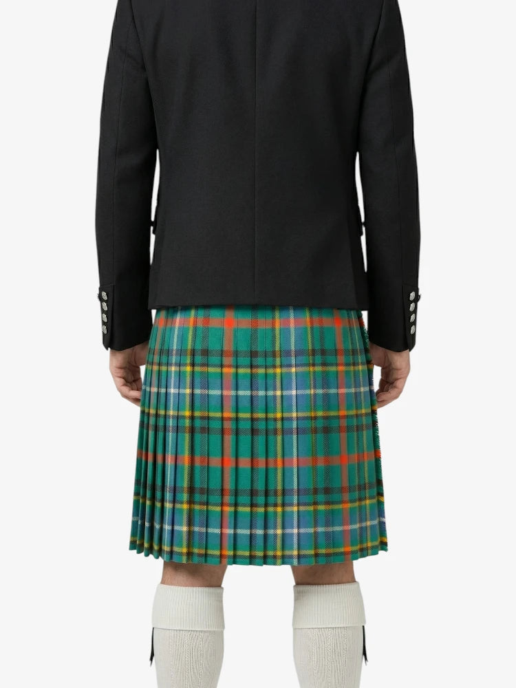 Person wearing a black jacket and green plaid kilt on a white background
