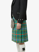 Person wearing a black jacket and green plaid kilt on a white background