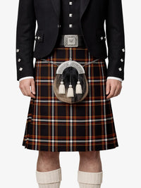Person wearing a traditional Scottish kilt with a tartan pattern on a white background